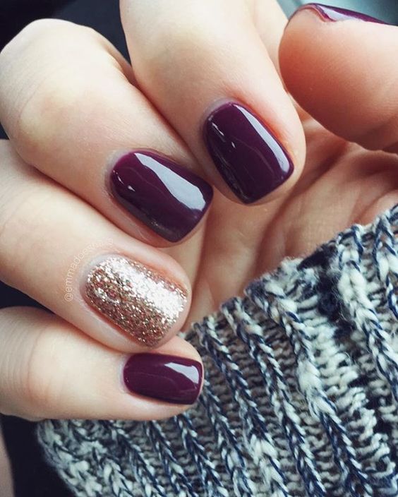 dark wine nails with one glitter accent nail