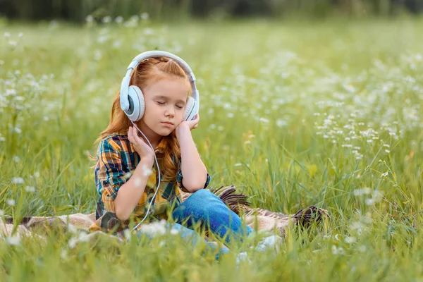 Little Kid Eyes Closed Listening Music Headphones While Resting Blanket — стоковое фото
