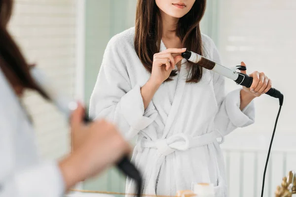 Cropped Shot Young Woman Bathrobe Using Hair Curler Mirror Bathroom — стоковое фото