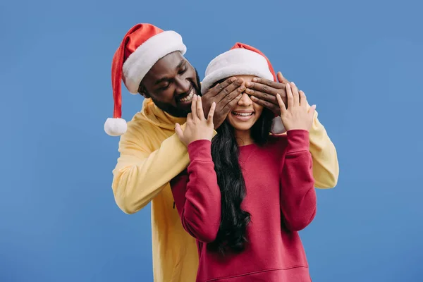 Smiling African American Man Christmas Hat Closing Eyes Girlfriend Isolated — стоковое фото