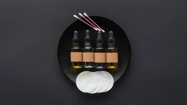 Top View Bottles Natural Oils Cosmetic Pads Plate Beauty Concept — стоковое фото